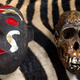 A carved Chimpanzee skull and the ceramic mask that hid it.